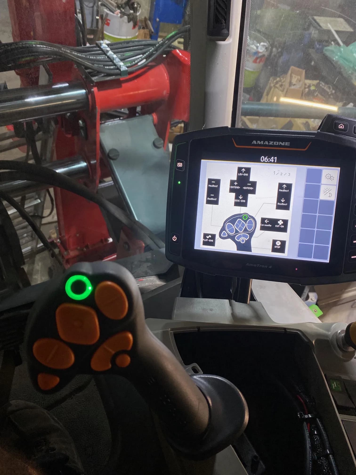 The AmaTron 4 terminal and AUX-N joystick in the Pantera's cab, with the build's functions on screen