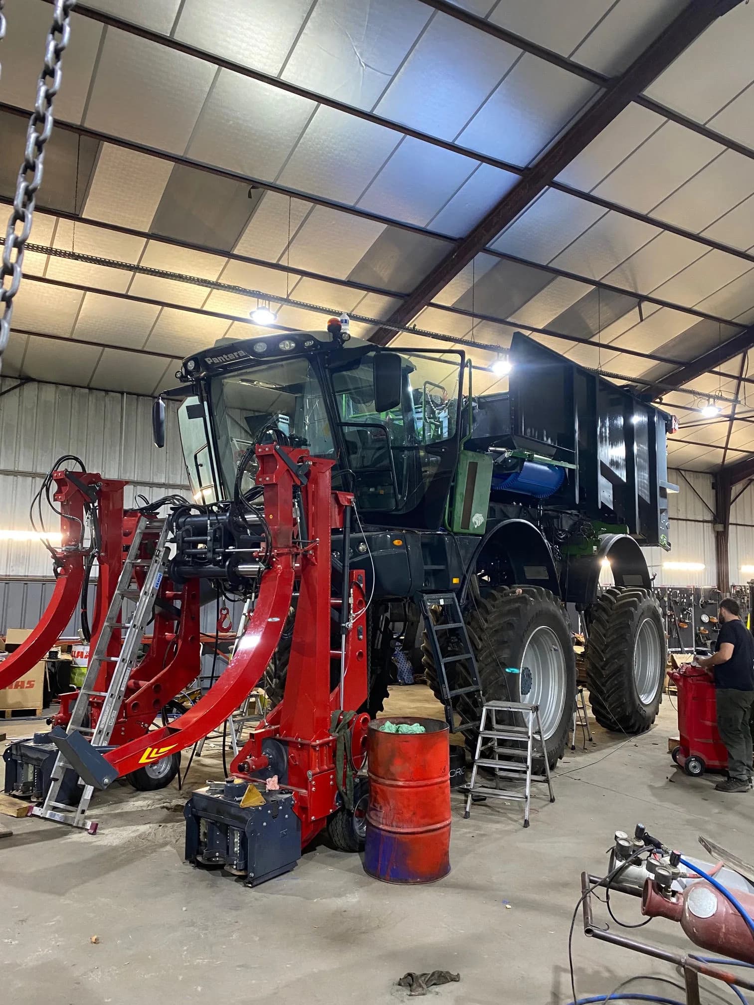 An Amazone Pantera in a workshop, mid-conversion from sprayer to harvesting machine