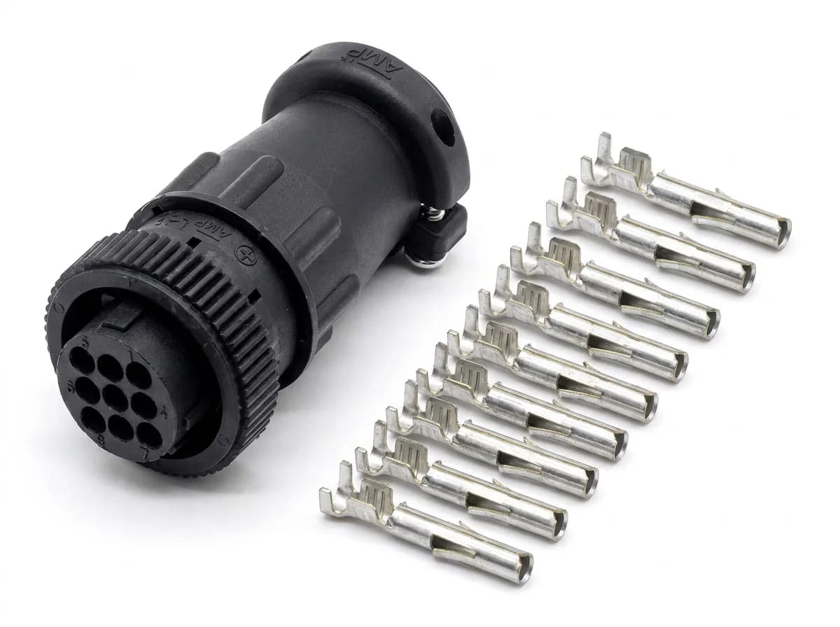 In-Cab Connector Kit: black 9-pin AMP circular plug with its cable clamp, beside the nine loose tin-plated crimp contacts that come with it