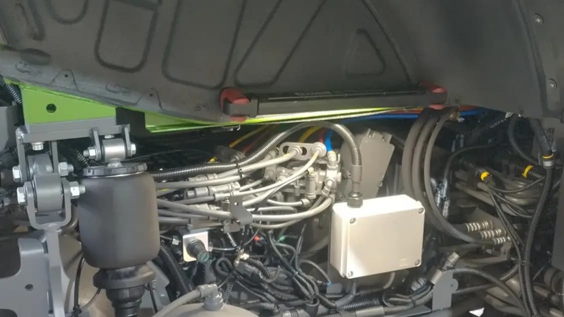 The weatherproof enclosure bolted under the tractor cab, tucked in with the existing chassis hardware
